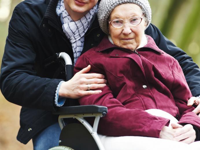 Carer with older woman in wheelchair